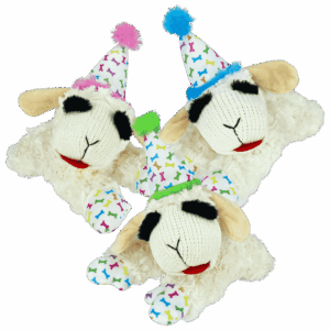 two stuffed sheep wearing party hats on a green background