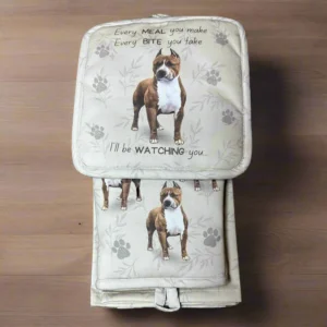 a brown and white dog sitting on top of a wooden floor