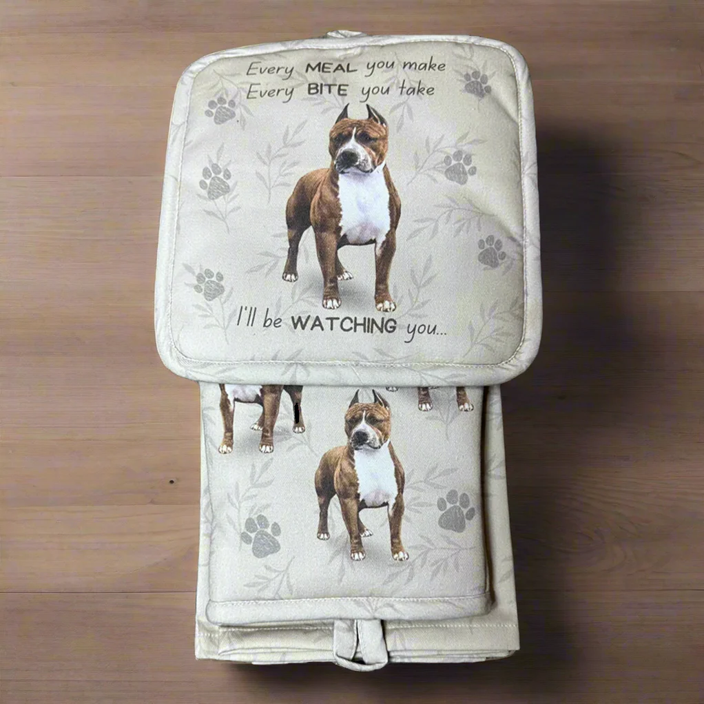 a brown and white dog sitting on top of a wooden floor