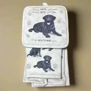 a black dog sitting on top of a white blanket