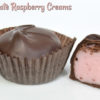 2 Dark Chocolate Raspberry Creams with one cut in half
