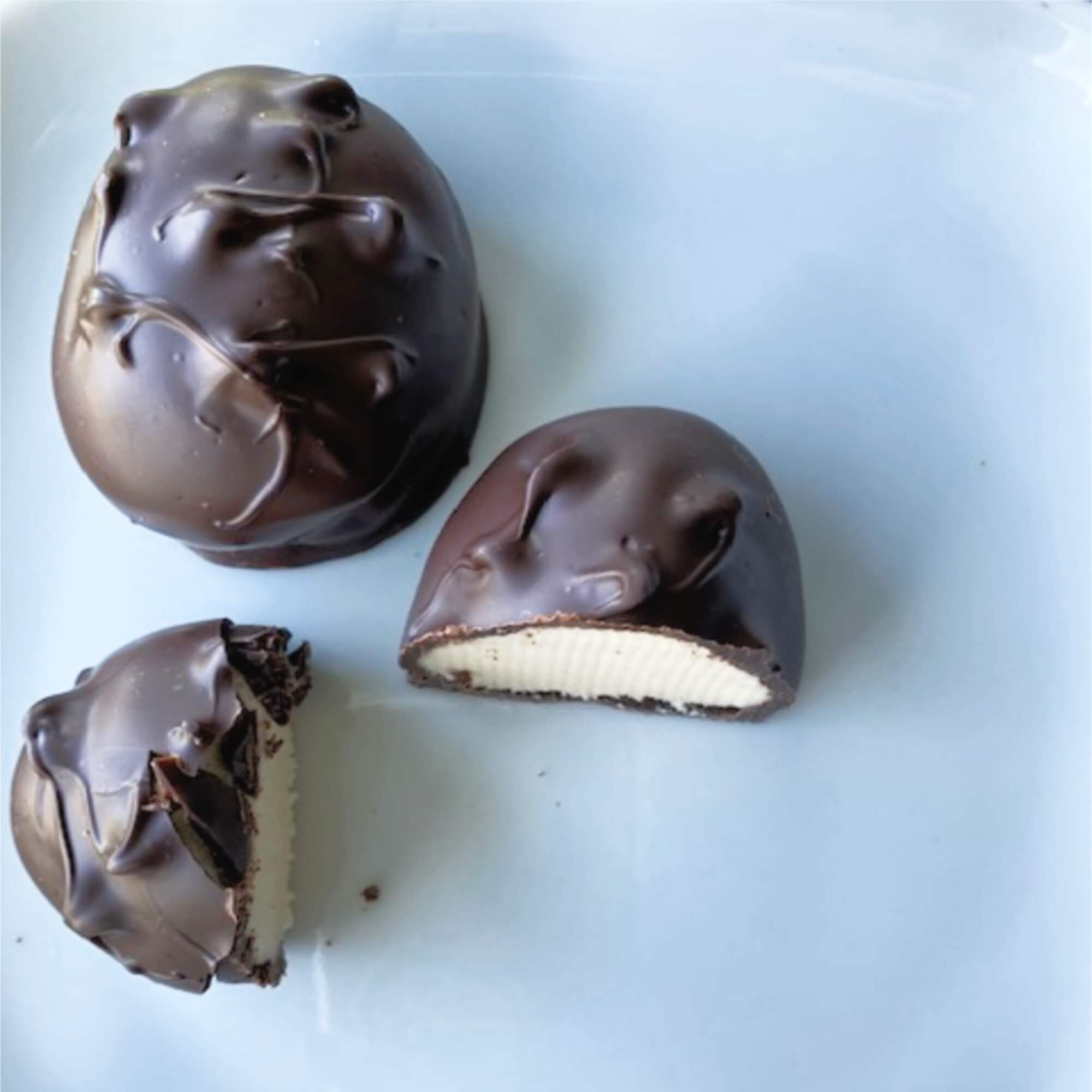 2 chocolate covered easter eggs with 1 split in 2