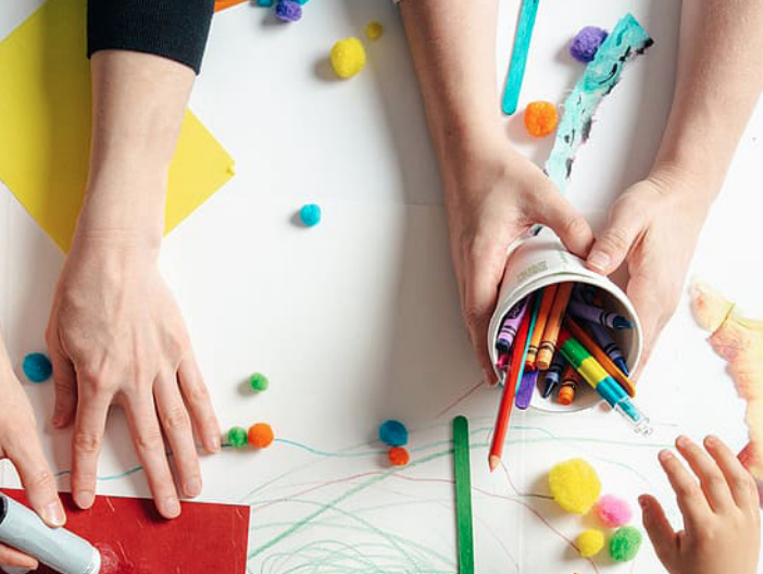 person holding crayons