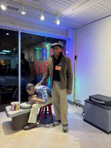 Ernie Satchell poses with “Labor of Love,” on display at the Dorchester Center for the Arts through February.