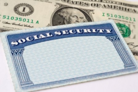 A blank social security card sits atop a $1 bill