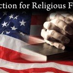 Hands folded over Bible with American flag