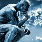 Stone statue of The Thinker with clouds in background