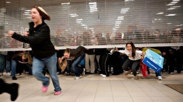 Black Friday shoppers climbing under store gates to get in