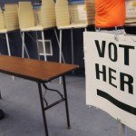 Voter booths with sign reading Vote Here