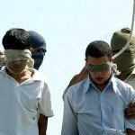Two young men prepare to be hanged while blindfolded