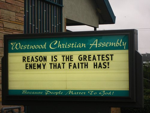 Sign reads Reason is the Greatest Enemy That Faith Has!