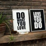 White and black alternating signs with quotes with brick background