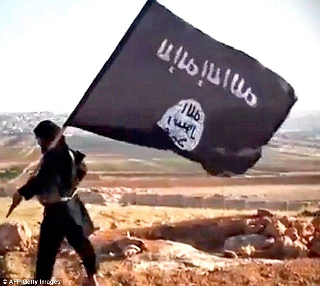 Person carrying ISIS flag walking the desert