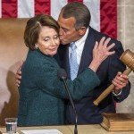 Boehner hugs and kisses Pelosi on the cheek while holding gavel