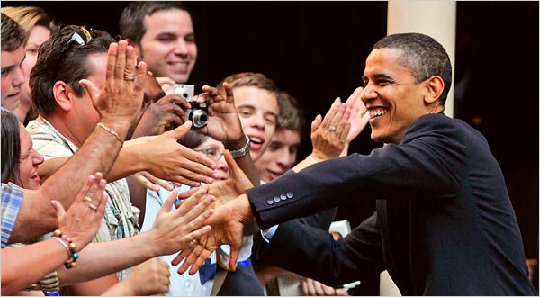 Obama shakes hands and poses for pictures