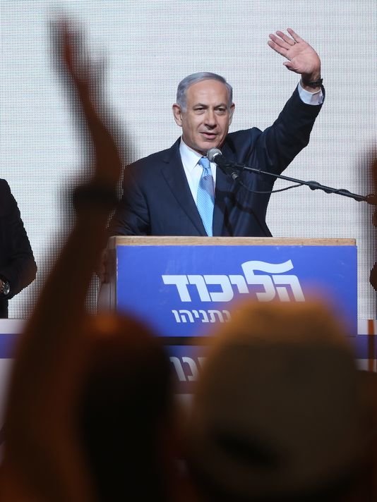 Prime Minister of Israel Netanyahu behind podium waving