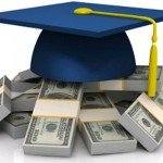 A blue graduation cap sits atop several clumps of money