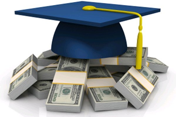 A blue graduation cap sits atop several clumps of money