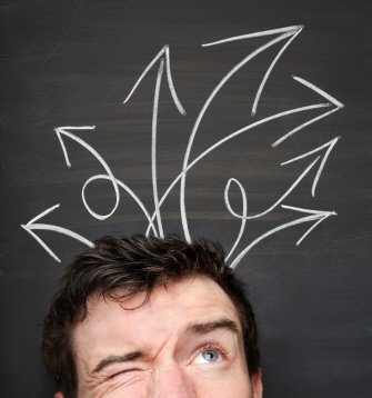 Man squints with chalk arrows pointing in all directions behind him