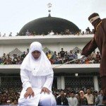 Woman in white hijab is canned by masked person by form of punishment