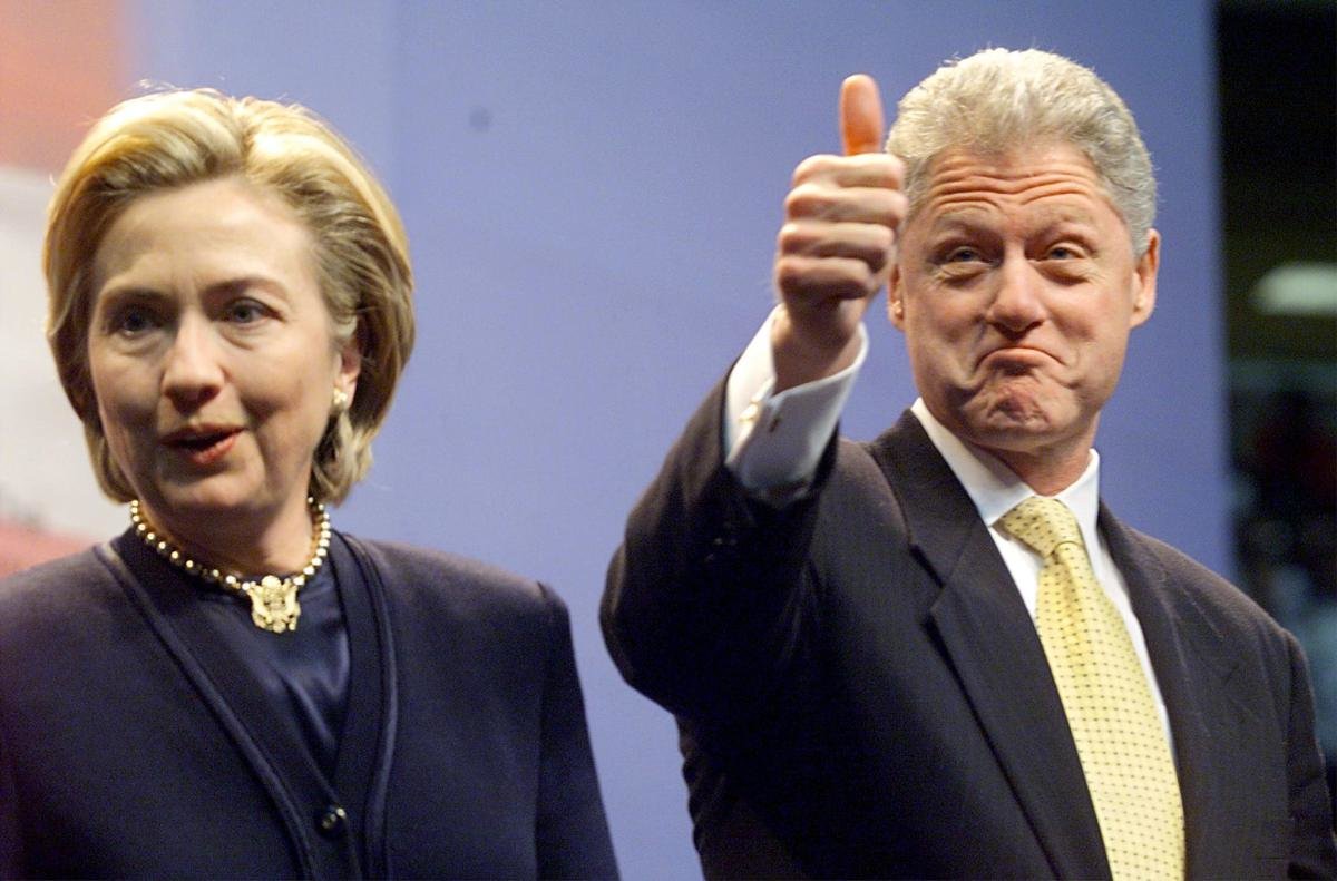 Hillary and Bill Clinton with smiles and Bill's thumbs up