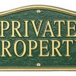 Green and gold sign that reads Private Property
