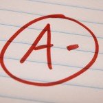 A- is written and circled in red on lined notebook paper