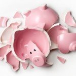 Pink piggy bank smashed into several pieces