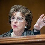 Dianne Feinstein holds hand up while speaking
