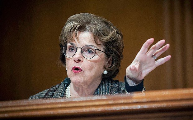 Dianne Feinstein holds hand up while speaking