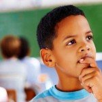 Young boy ponders with classroom classmates in background