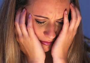 Woman holds face in emotional distress