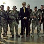 Military men lined up armed with rifles