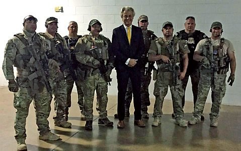 Military men lined up armed with rifles