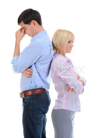 A couple stand back to back with woman's arms crossed