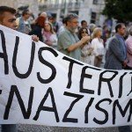 Protestors hold banner that reads Austerity = Nazism