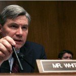 Politician Sheldon Whitehouse at conference with name plaque