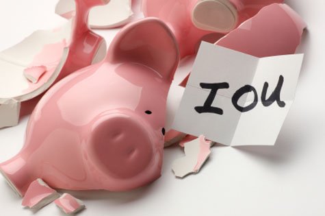 Smashed pink piggy bank with note that reads IOU