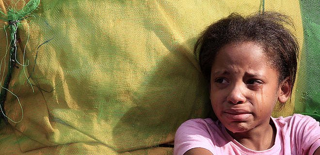 Young girl with tears streaming down her cheeks