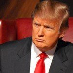 Donald Trump sitting in a red chair with a red tie