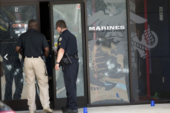 Cops investigate the door frame of the Marines office in Chattanooga