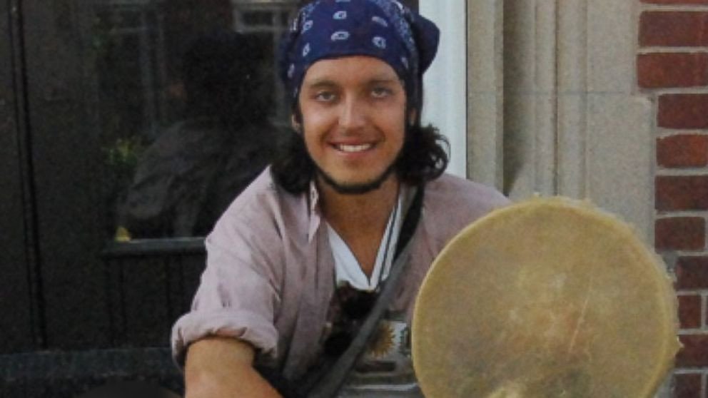Alexander Ciccolo sitting on doorstep with reflection in background