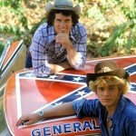 Actors pose with car with confederate flag on roof