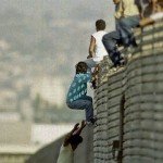 Immigrants climbing over Mexican border