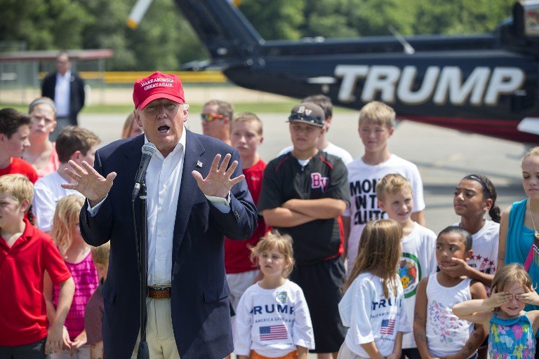 Donald Trump gives speech as young kids stand in background