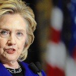 Hillary Clinton gives speech with American flag in background