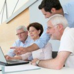 Young man presents to older individuals