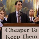 Scott Walker gives speech as people stand behind him