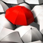 A red umbrella mixed in the middle of all white umbrellas