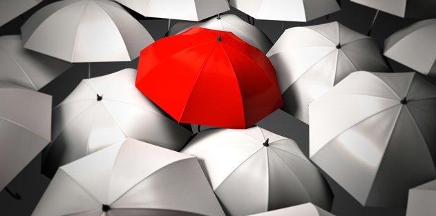 A red umbrella mixed in the middle of all white umbrellas